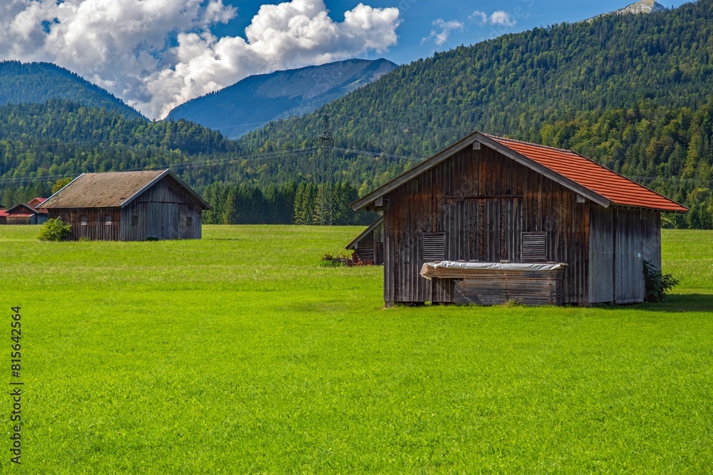 Scenic Alpine landscape with a green field and rural houses. Upper Bavaria, Germany Scenic Alpine landscape with a green field and rural houses. Upper Bavaria, Germany