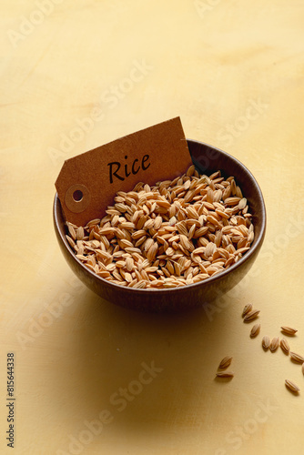 Bowl with rice on yellow background