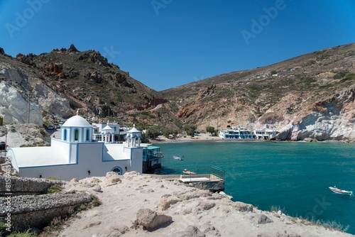 Scenic view of small boats docked at the edge of the shoreline, with a backdrop of water photo