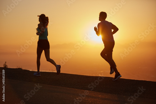 Sunrise, couple and running silhouette outdoor for race training, exercise and fitness with cardio for health. Wellness, sport and athlete with runner partner in nature in the morning with sprint