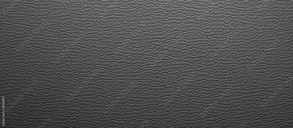 A dark gray plastic texture is used as a background for a copy space image A dark gray plastic texture is used as a background for a copy space image