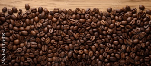 Close up coffee beans and and lined paper on wooden table top view. copy space available