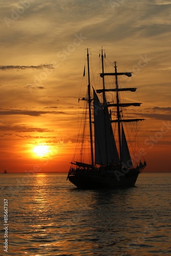 фотографія Majestic sailing ship illuminated by the setting sun