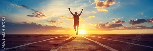 Triumphant marathon runner crossing the finish line with arms raised in light photography. Banner
