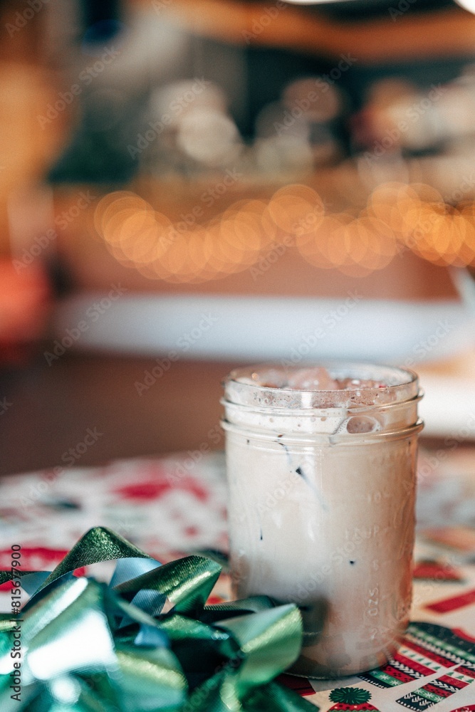 Glass of Christmas iced peppermint mocha sits on a table adorned with Christmas decorations Glass of Christmas iced peppermint mocha sits on a table adorned with Christmas decorations