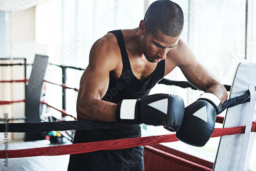 Fototapeta Naklejka Na Ścianę i Meble -  Tired, boxer and man in ring at gym for challenge, exercise or fail training competition for body health. Stress, fight and sport athlete resting on break with fatigue, defeat or depression