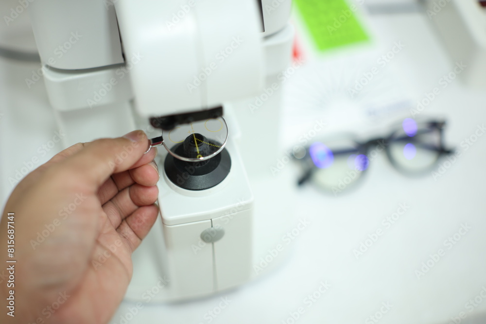 close up of a hand holding a lenses glasses close up of a hand holding a lenses glasses