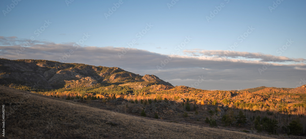 Obraz premium View of beautiful countryside at sunset. Beautiful autumn landscape in the hilly. Grassy field and hills. Rural landscapes.
