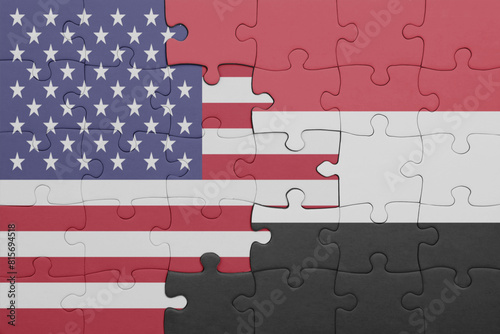 puzzle with the colourful national flag of yemen and flag of united states of america .