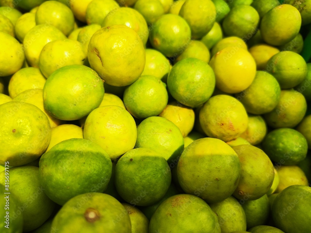 Close-up of a cluster of fresh limey lemons on a display Close-up of a cluster of fresh limey lemons on a display