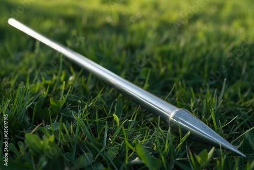 A stunning hyper-realistic shot of a javelin resting on a lush grass field