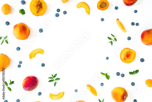 Peaches fruits with blueberry and mint on white background. Summer concept. Flat lay © artifirsov
