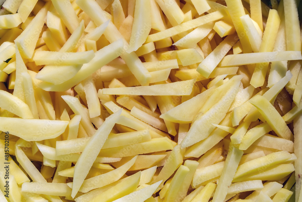 Peeled and chopped potatoes before cooking. Sliced natural potatoes close-up Peeled and chopped potatoes before cooking. Sliced natural potatoes close-up
