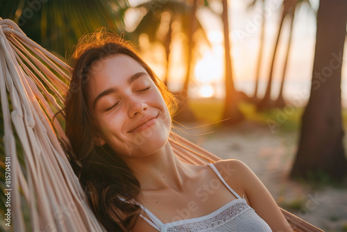 Woman napping on a hammock by the beach during sunset. Vacation beach summer holiday