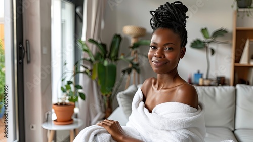 Serene young dark-skinned woman enjoying tranquility at home in a white robe