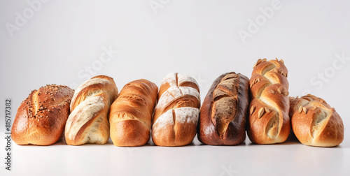 Various assortment of fresh bread in a row, white background isolate. AI generated.