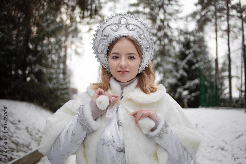Snow Maiden , a cute young blonde in a white snow maiden costume with kokoshnik Snow Maiden , a cute young blonde in a white snow maiden costume with kokoshnik