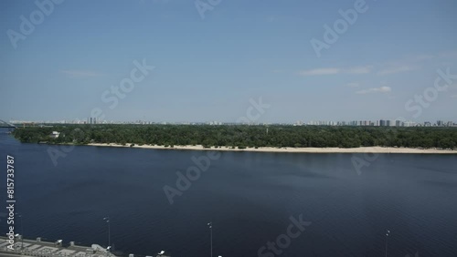 a large river and a bank with trees and bushes photo
