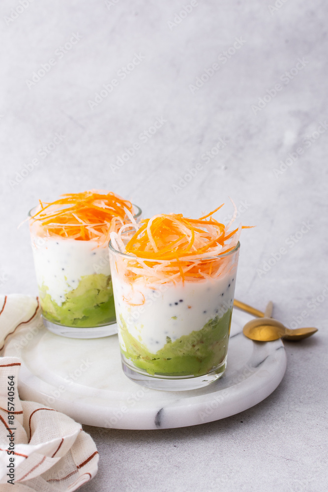 Healthy breakfasts and lunches, avocado and yogurt with chia, grated carrots and radishes in glass cups Healthy breakfasts and lunches, avocado and yogurt with chia, grated carrots and radishes in glass cups