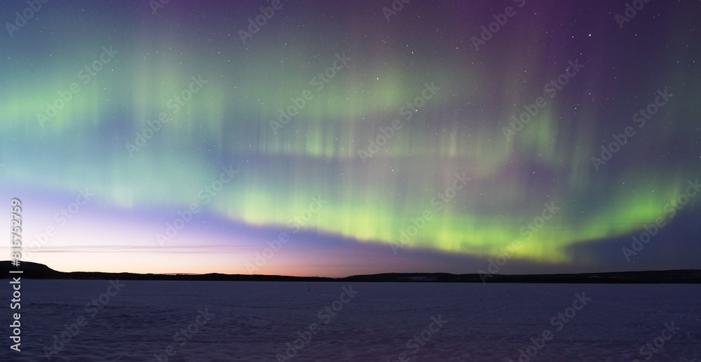 Northern Lights by the frozen lake in Lapland, Finland Northern Lights by the frozen lake in Lapland, Finland