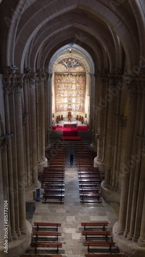 Overhead view of the central nave and main chapel of the old cathedral of Salamanca, Castilla y Leon, Spain, with a man walking. Vertical video photo