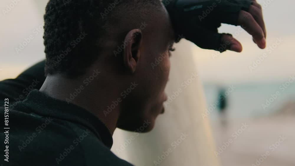 Close-up side view of a man during street workout, tired athlete resting between sets Close-up side view of a man during street workout, tired athlete resting between sets
