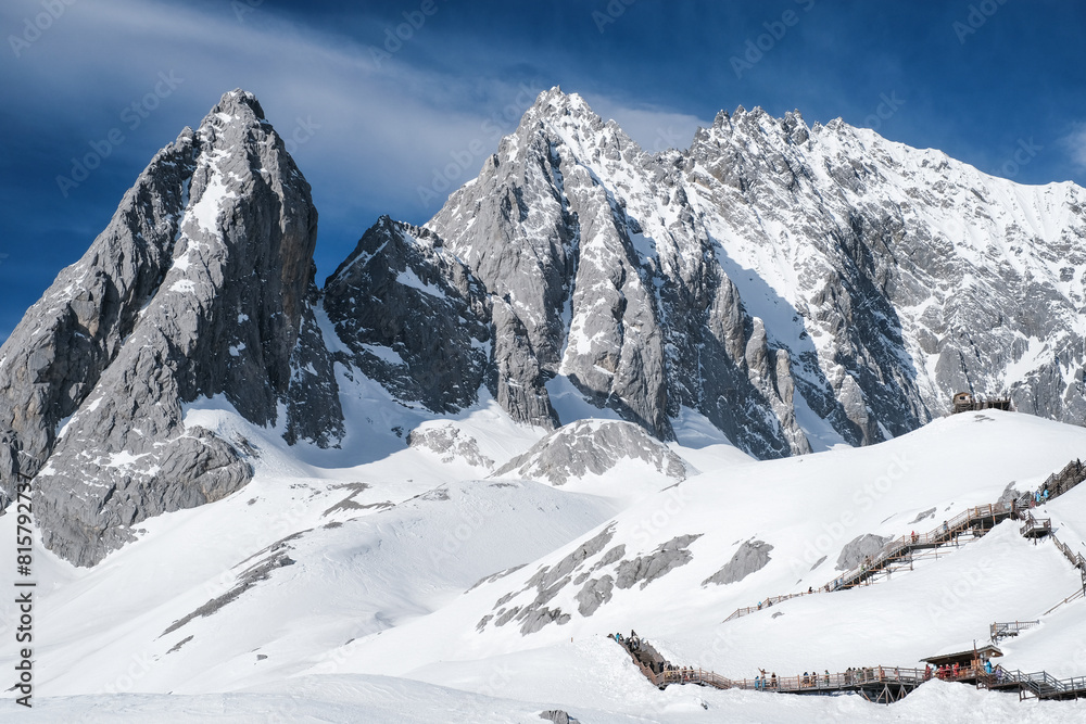 Fototapeta premium Nature view Jade Dragon Snow Mountain with soft white cloud on blue sky and soft sunlight in morning, Shangri-La City or Xiang Ge Le La at Yunnan, China