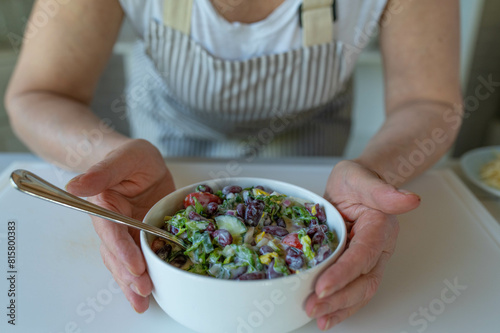 Fresh kidney bean salad with romaine lettuce, tomatoes, cucumber, onione and chives