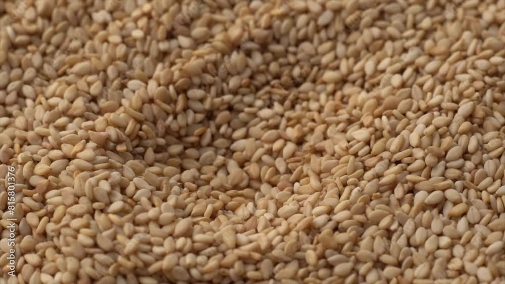 Macro video of sesame seeds. Bunch of sesame seeds placed on rotating disk. Macro video of sesame seeds. Bunch of sesame seeds placed on rotating disk.