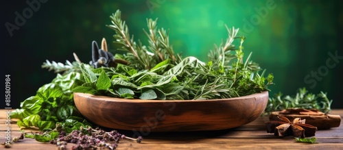 A closeup view of various fresh herbs placed in a wooden bowl on a table leaving room for text or other visual elements in the image. Copyspace image © StockKing