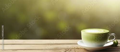 There is a cup of matcha latte with a delightful aroma placed on a wooden table leaving room for text. Copyspace image
