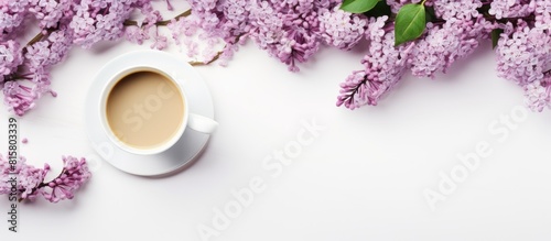 A minimal concept for a wedding or Valentine s Day with a copy space image of a morning breakfast featuring a coffee cup and lilac flowers on a white background photo