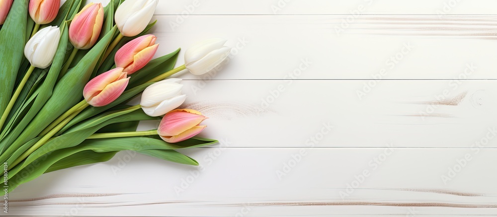 Copy space image of a Easter greeting card displayed on a white wooden table adorned with a beautiful bouquet of tulip flowers Copy space image of a Easter greeting card displayed on a white wooden table adorned with a beautiful bouquet of tulip flowers