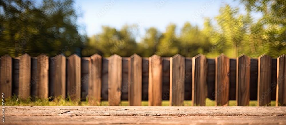Fototapeta premium A closeup of a small wooden fence on a sunny day outdoors providing a copy space image for text