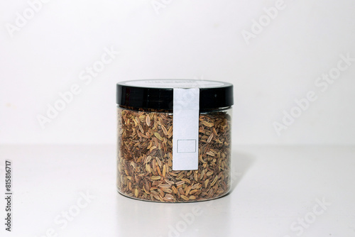 Plastic container with herbal tea, a blend of fennel, anise, and caraway seeds.