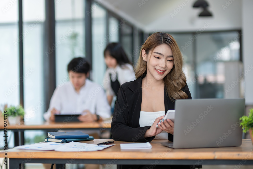 Beautiful accountant sitting with laptop calculating financial and tax figures for company on table in office room