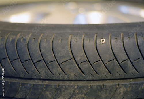 Obraz na płótnie Prorosive car tire with almost no rubber tread and a retracted metal screw w salonie