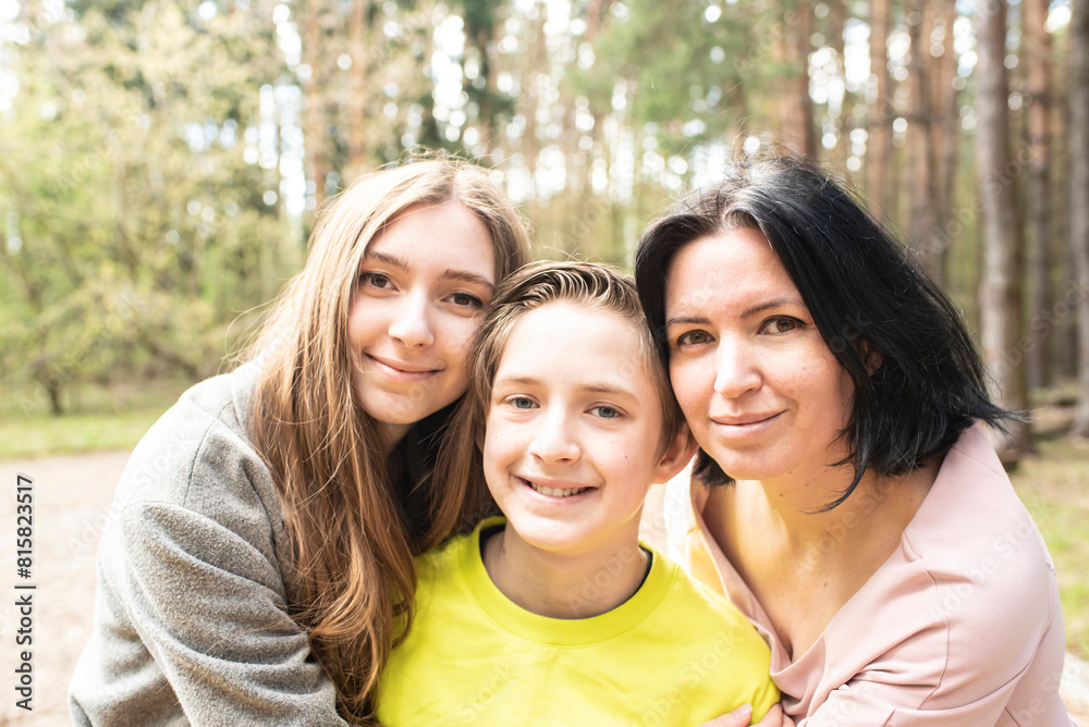 Obraz premium portrait of a happy 11 year old boy with his older sister and mom