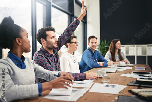 Businessman, team diversity and raising hand for question in boardroom, office and workspace for faq. Businesspeople, meeting and query or point for finances with smile, notebook and collaboration