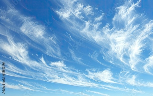 A serene blue sky with wispy white clouds drifting gently. photo