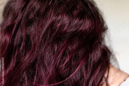 Woman with dark red hair, treatment with natural pigments based on blackberries and cherries