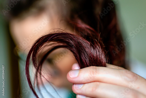 Woman with dark red hair, treatment with natural pigments based on blackberries and cherries