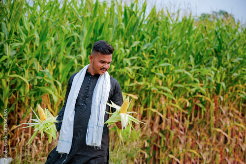 In a cornfield, a young Indian farmer