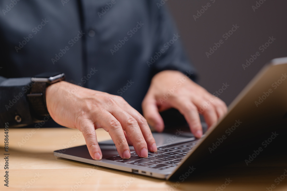 A man is typing on a laptop computer A man is typing on a laptop computer