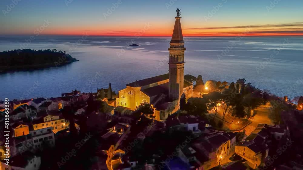 Evening HDR shot of Church of Saint Euphemia in old town of Rovinj, Croatia. Sea and sunset sky at background, aerial shot, 4K