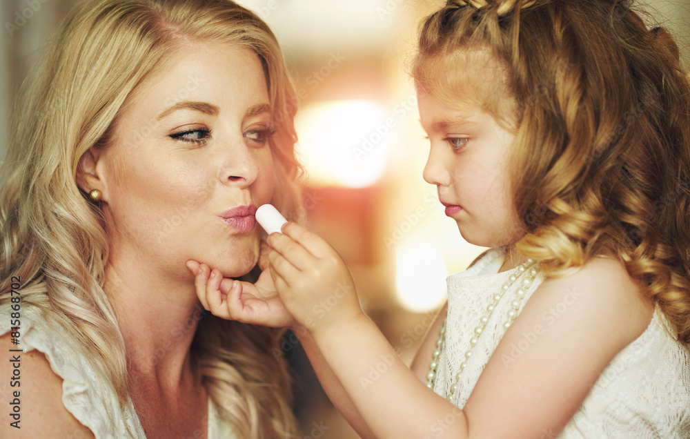 Lipstick, mother or child play with makeup in home for beauty, care or family bonding together. Girl, mom or kid apply lip cosmetics on face, learning or parent teaching daughter to paint in bathroom Lipstick, mother or child play with makeup in home for beauty, care or family bonding together. Girl, mom or kid apply lip cosmetics on face, learning or parent teaching daughter to paint in bathroom