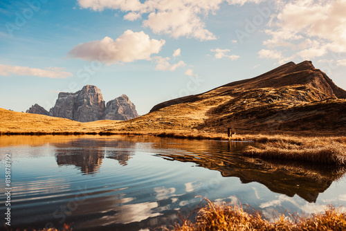 View of the Pelmo mountain on the Lake of Baste, Dolomites, Italy with a dog photo