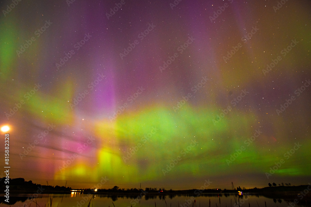The Aurora Borealis or northern lights creates a incredible display of beautiful multi colored light in the sky above North Dakota. The Aurora Borealis or northern lights creates a incredible display of beautiful multi colored light in the sky above North Dakota.