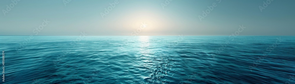 Obraz premium The image shows a beautiful seascape with a bright sun rising over the horizon and shimmering on the surface of the water.