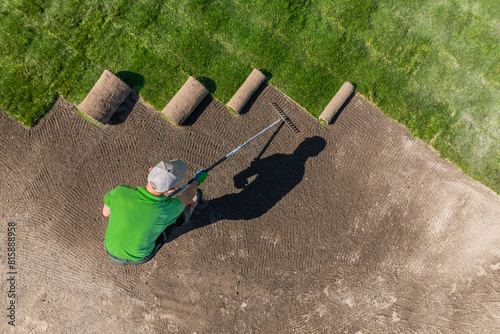 Man Installing Grass Turfs on a Golf Course Aerial View. photo